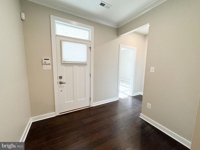 foyer with ornamental molding and dark wood-type flooring