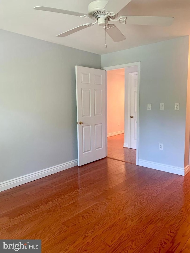 spare room with hardwood / wood-style flooring and ceiling fan