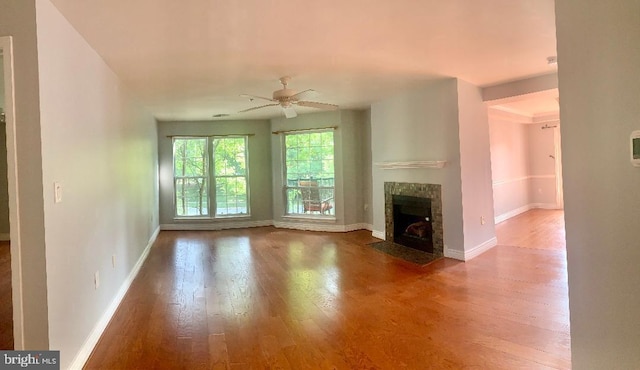 unfurnished living room with ceiling fan and wood-type flooring