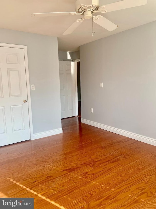 spare room featuring wood-type flooring and ceiling fan