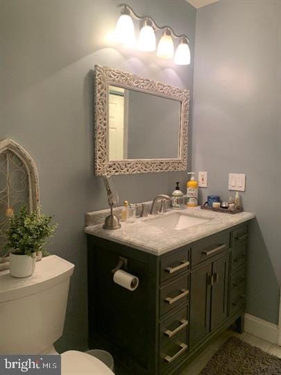 bathroom with vanity, toilet, and tile patterned flooring