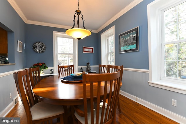 dining room with crown molding and dark hardwood / wood-style floors