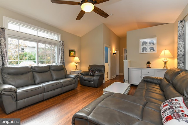 living room with lofted ceiling, dark wood-type flooring, and ceiling fan