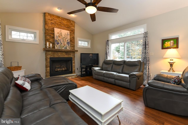 living room featuring dark wood-type flooring, ceiling fan, lofted ceiling, and a fireplace