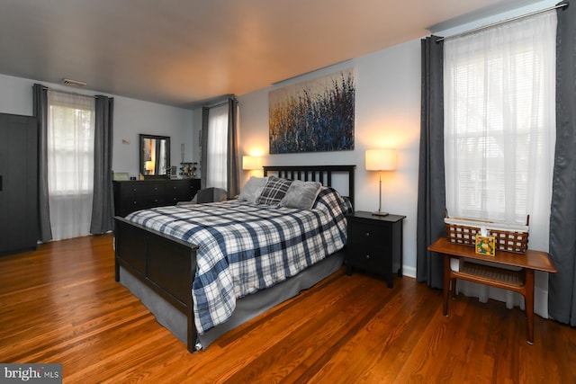 bedroom with dark wood-type flooring