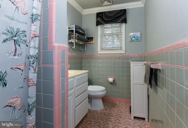 bathroom with vanity, ornamental molding, tile walls, and toilet