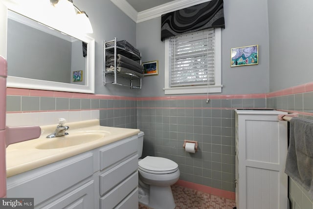 bathroom with crown molding, vanity, toilet, and tile walls