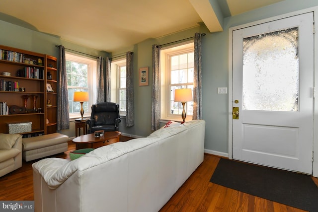 living room with beamed ceiling and hardwood / wood-style floors