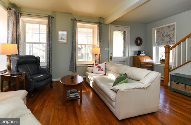 living room with dark wood-type flooring and beam ceiling