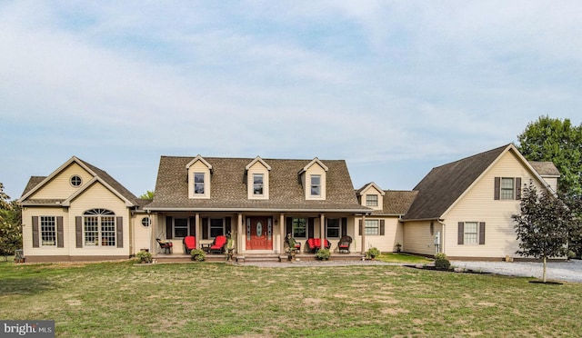 cape cod house featuring a porch and a front lawn