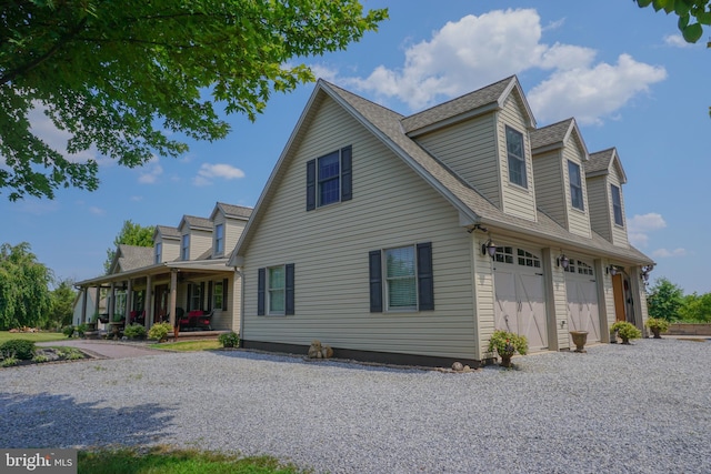 view of front of property featuring a porch and a garage