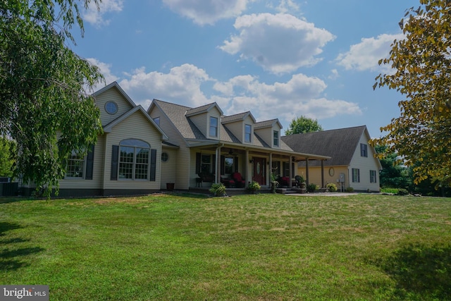 cape cod house featuring covered porch and a front yard