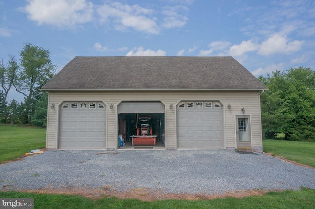 garage featuring a lawn