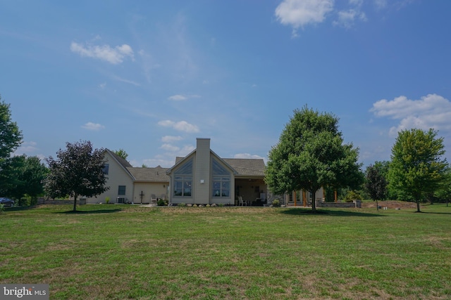 back of house with a lawn