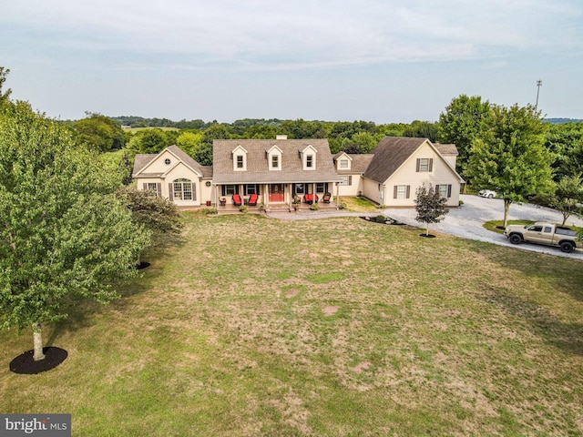 cape cod-style house with a porch and a front lawn