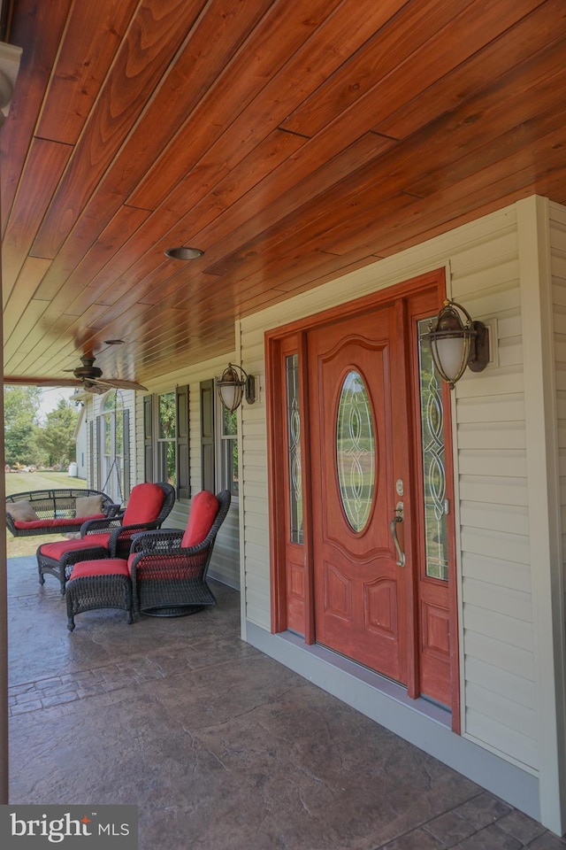 view of exterior entry featuring ceiling fan