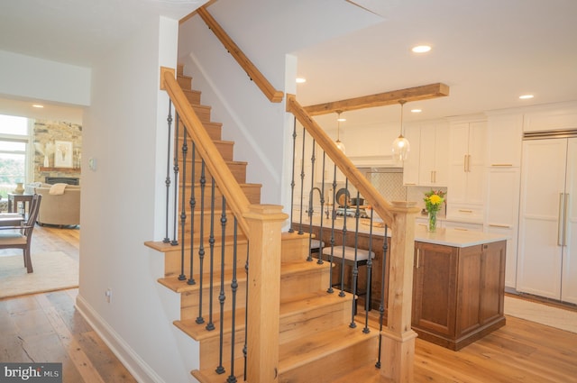 staircase with hardwood / wood-style flooring