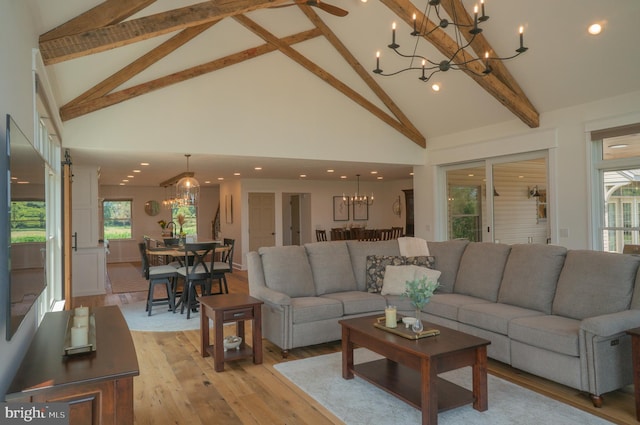 living room featuring an inviting chandelier, high vaulted ceiling, light hardwood / wood-style floors, and beamed ceiling