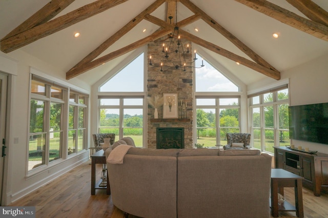 living room featuring hardwood / wood-style flooring, high vaulted ceiling, and a fireplace