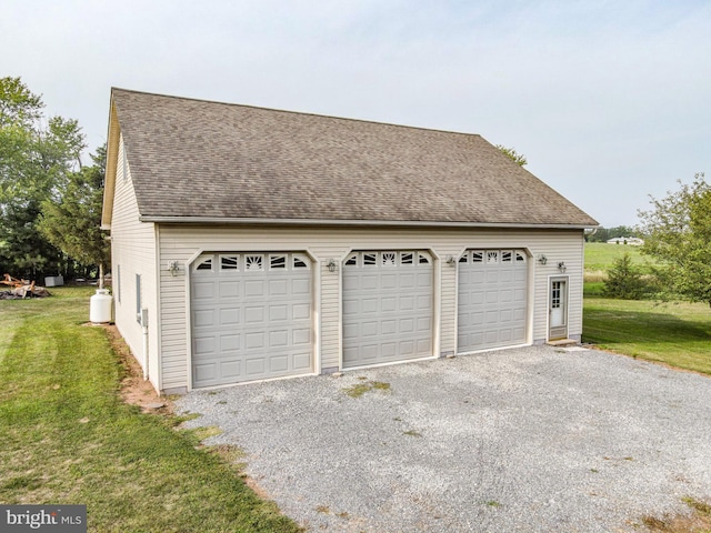 garage featuring a lawn