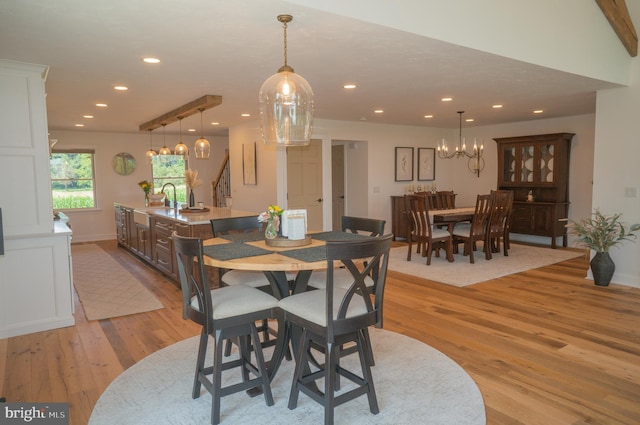 dining room with light hardwood / wood-style floors and sink