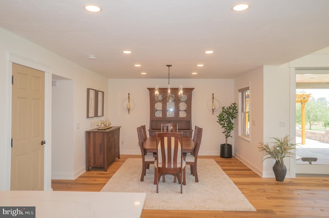 dining area featuring a chandelier and light hardwood / wood-style floors