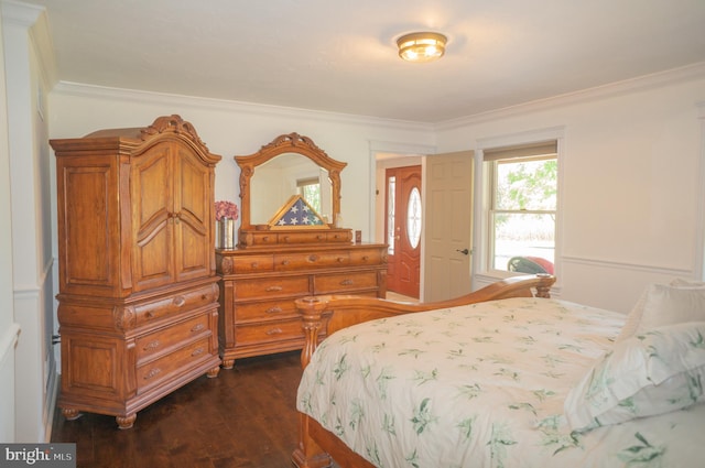 bedroom featuring ornamental molding and dark hardwood / wood-style floors