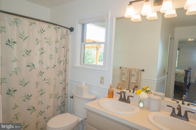 bathroom with vanity, curtained shower, and toilet