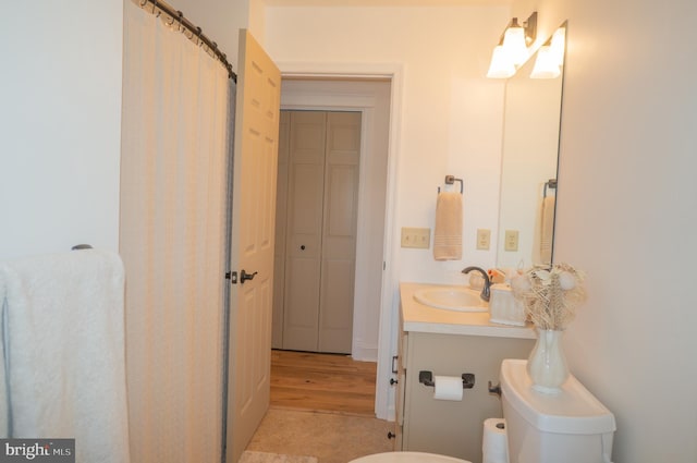 bathroom featuring vanity and toilet