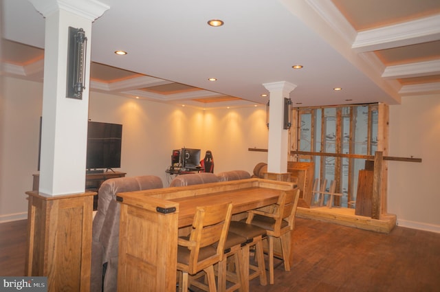 dining area featuring ornamental molding, dark hardwood / wood-style floors, and decorative columns