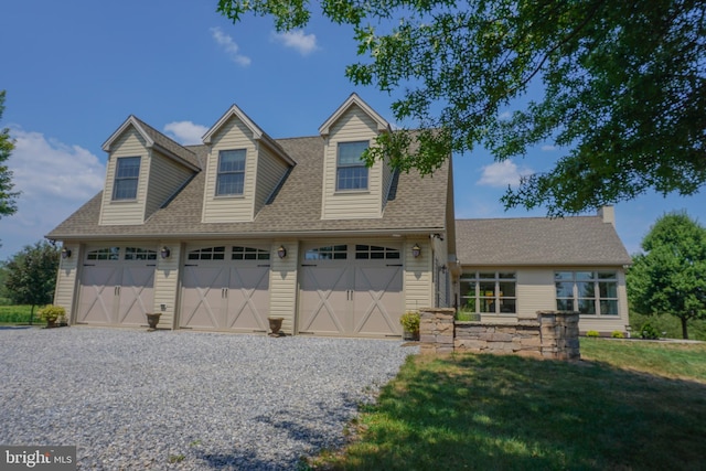 view of front facade with a garage and a front lawn