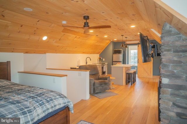 bedroom featuring vaulted ceiling, wood ceiling, and light hardwood / wood-style flooring