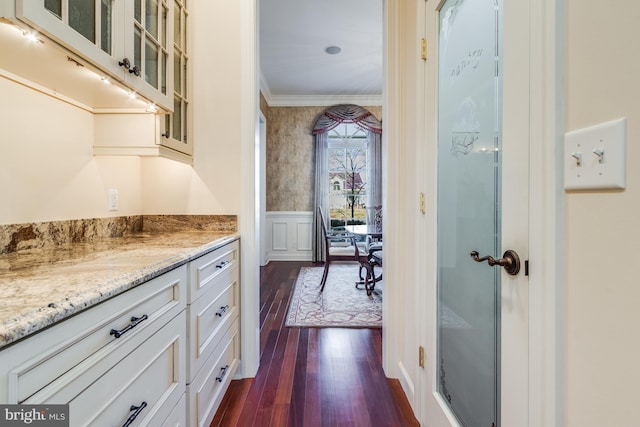 corridor featuring ornamental molding and dark hardwood / wood-style floors