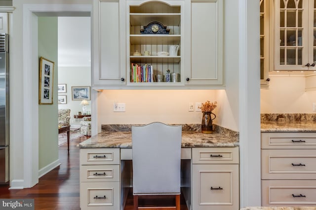 office area with dark hardwood / wood-style floors and built in desk