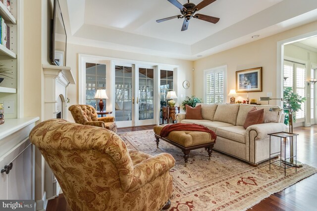 living room featuring hardwood / wood-style floors, a wealth of natural light, ceiling fan, and french doors