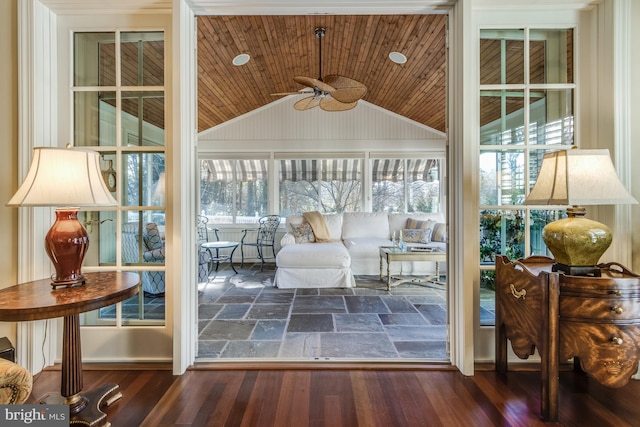 interior space with dark wood-type flooring, vaulted ceiling, and wooden ceiling