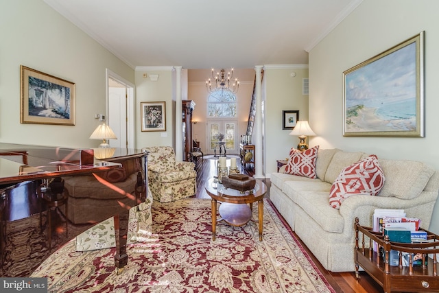 living room featuring hardwood / wood-style floors, a notable chandelier, and ornamental molding