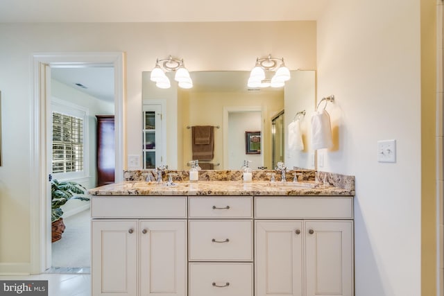 bathroom featuring vanity and an enclosed shower