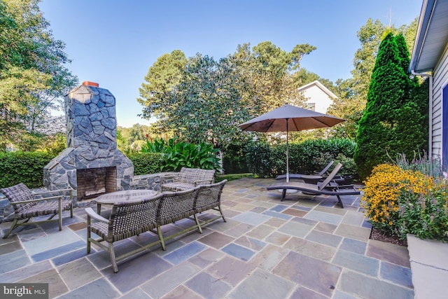 view of patio / terrace with an outdoor stone fireplace