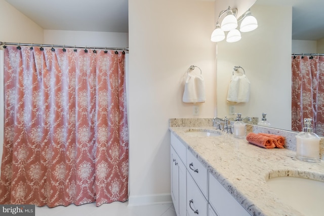 bathroom featuring tile patterned flooring and vanity