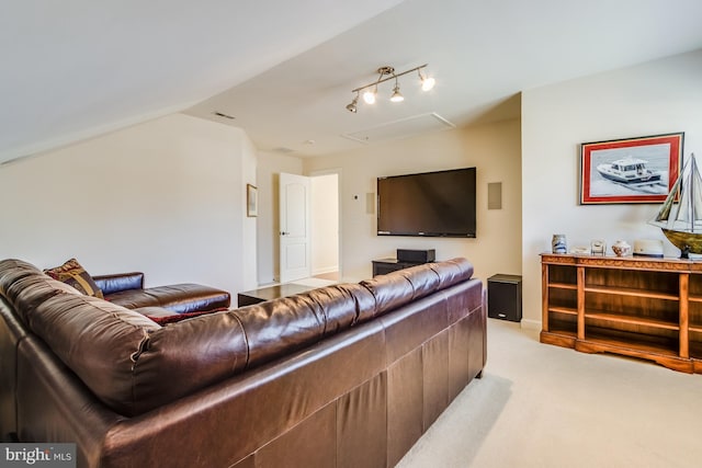 carpeted living room with rail lighting