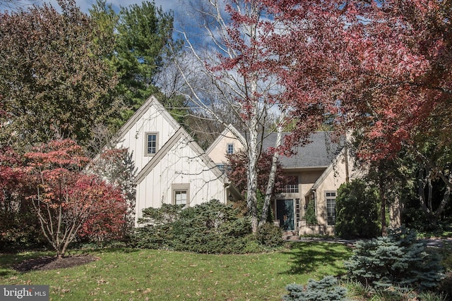 view of property hidden behind natural elements with a front lawn