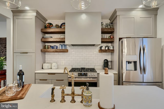 kitchen featuring tasteful backsplash, decorative light fixtures, stainless steel appliances, and gray cabinetry