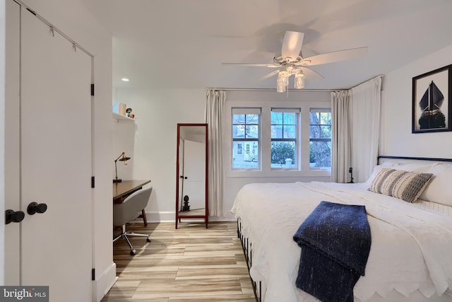 bedroom featuring light hardwood / wood-style flooring and ceiling fan