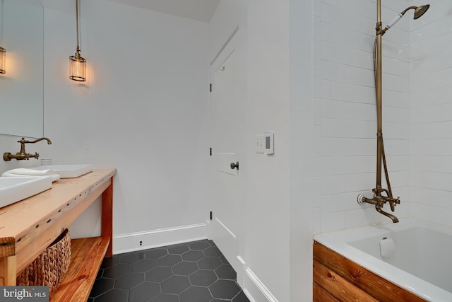 bathroom featuring tiled shower / bath combo, vanity, and tile patterned flooring