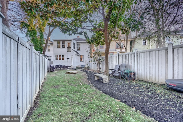 view of yard featuring an outdoor fire pit