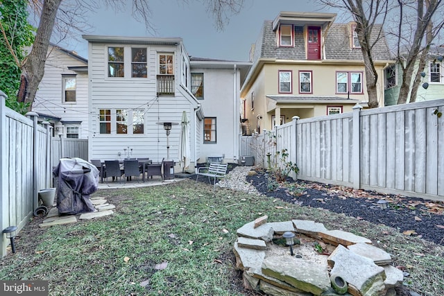 rear view of house with a patio and a yard