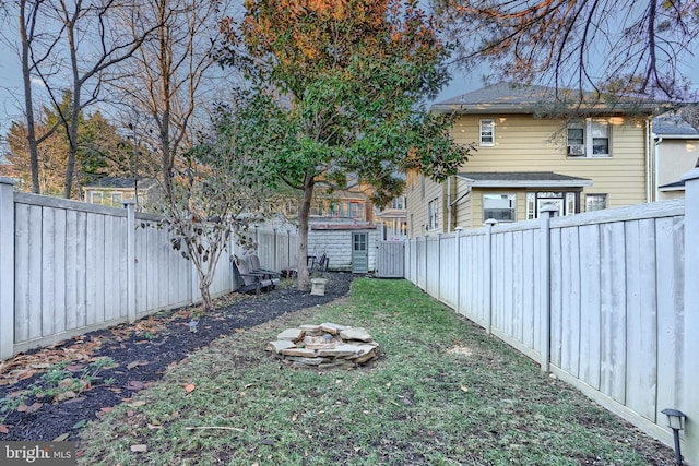 view of yard with an outdoor fire pit