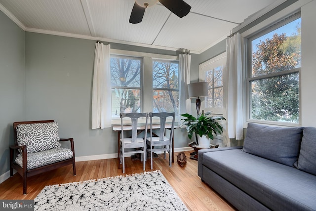 sunroom / solarium featuring ceiling fan