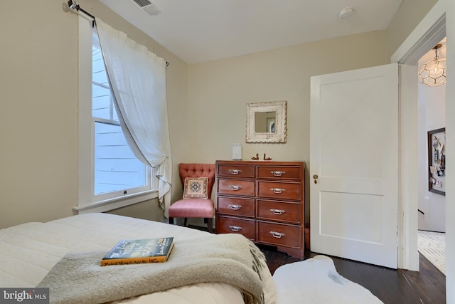 bedroom with dark hardwood / wood-style flooring